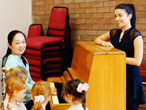 Mari at the piano with children